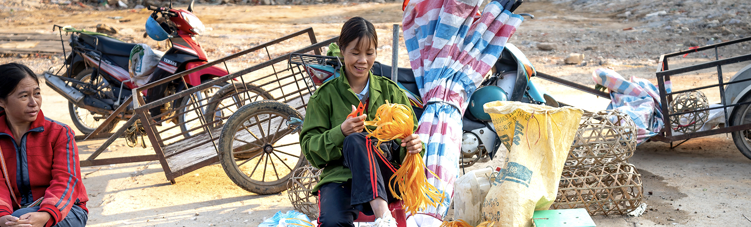 Asian women working on local market on street